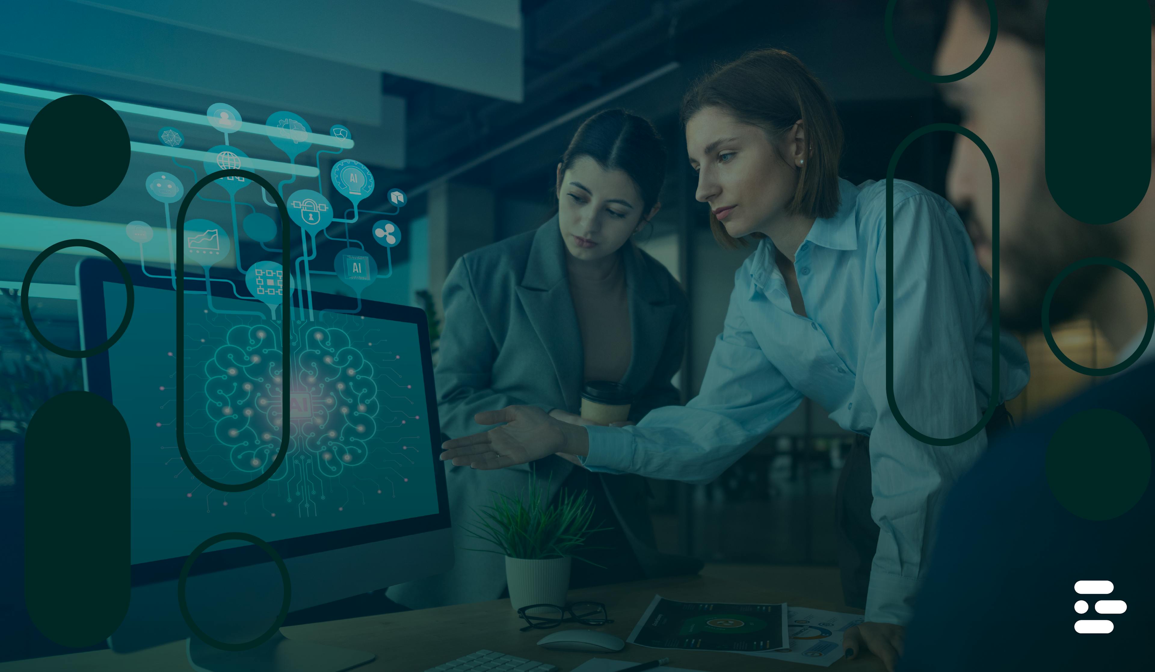 Two women discussing AI displayed on a computer screen