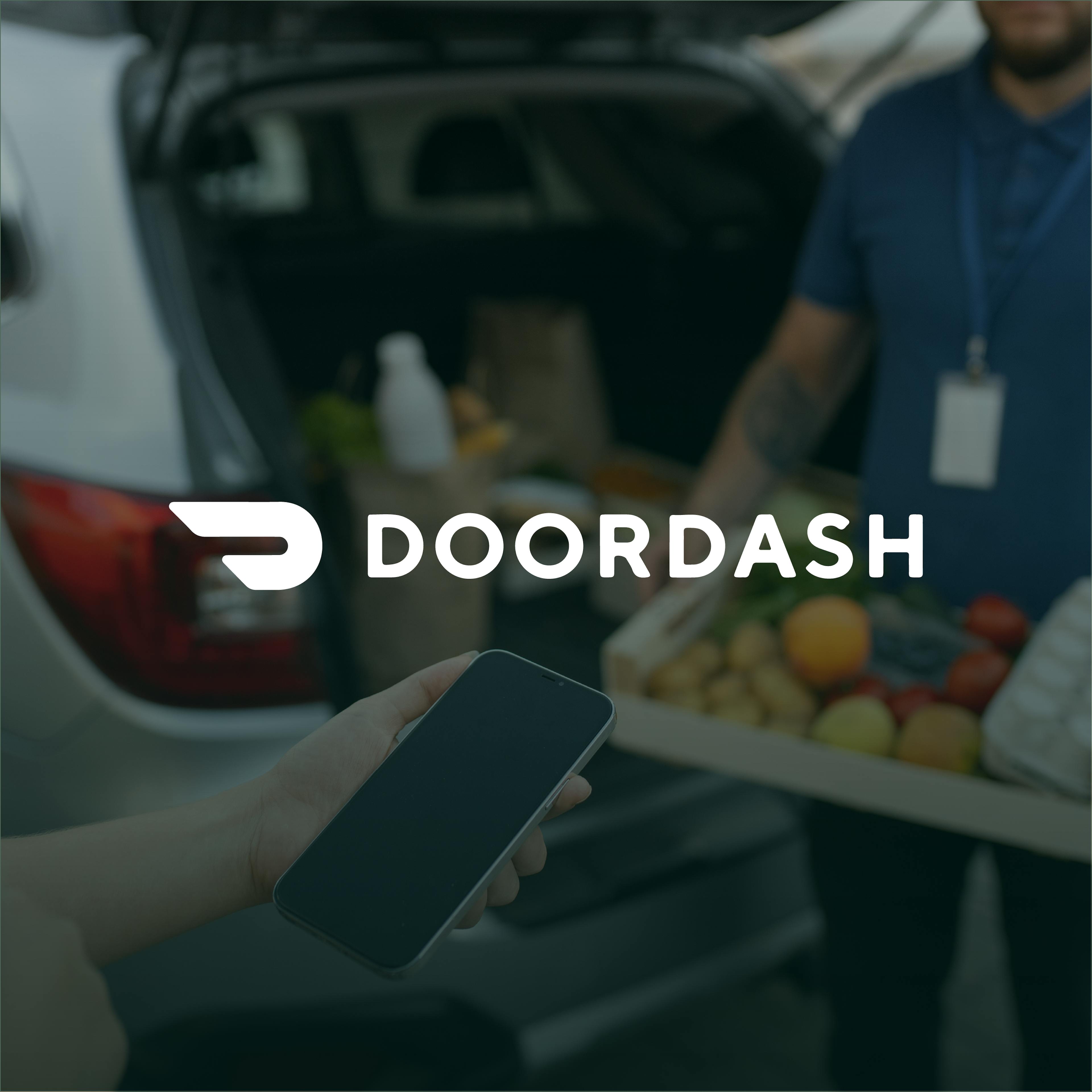 Hand holding a phone with DoorDash logo overlay, delivery in the background.