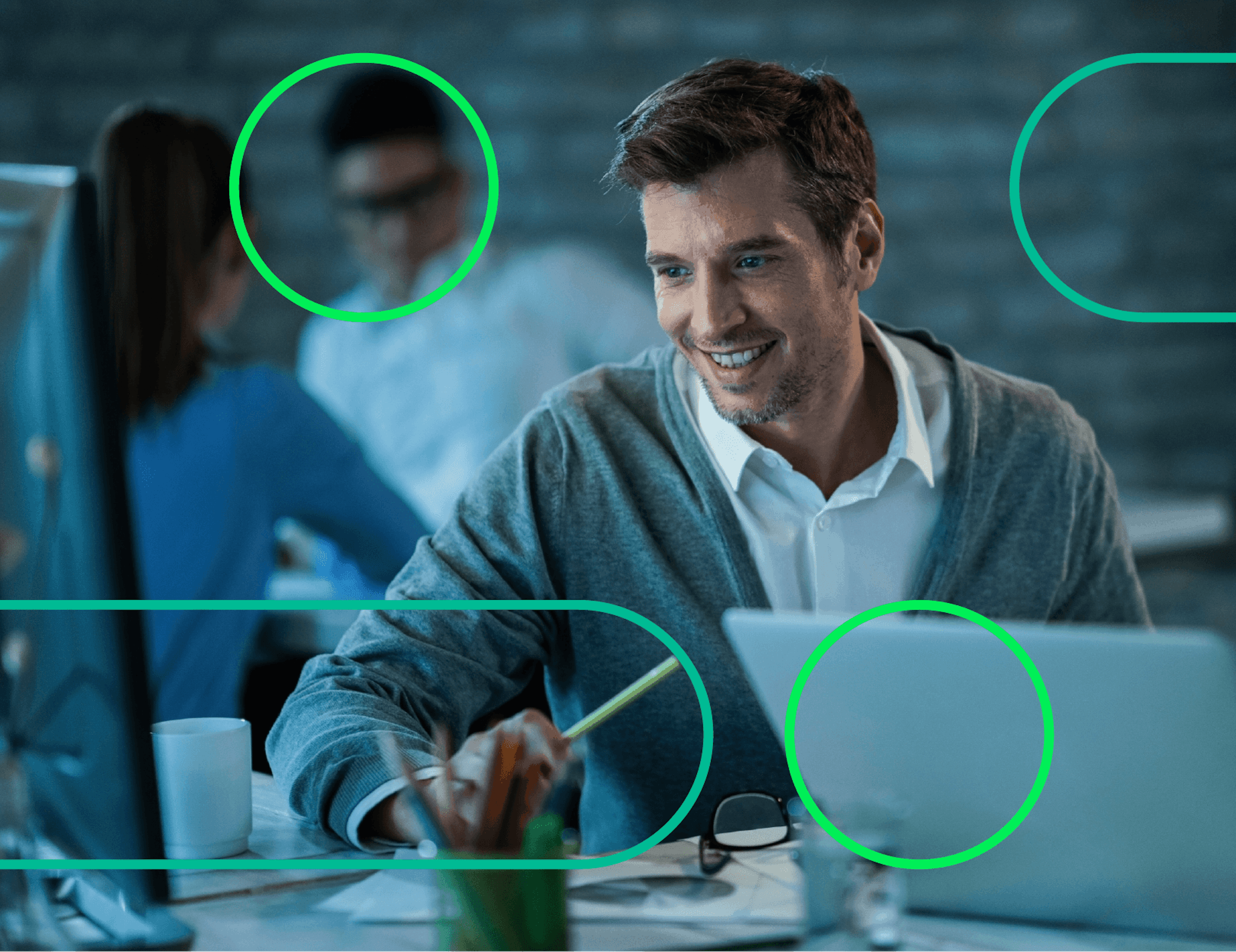 Smiling man working on a laptop in a collaborative office environment with abstract design elements.