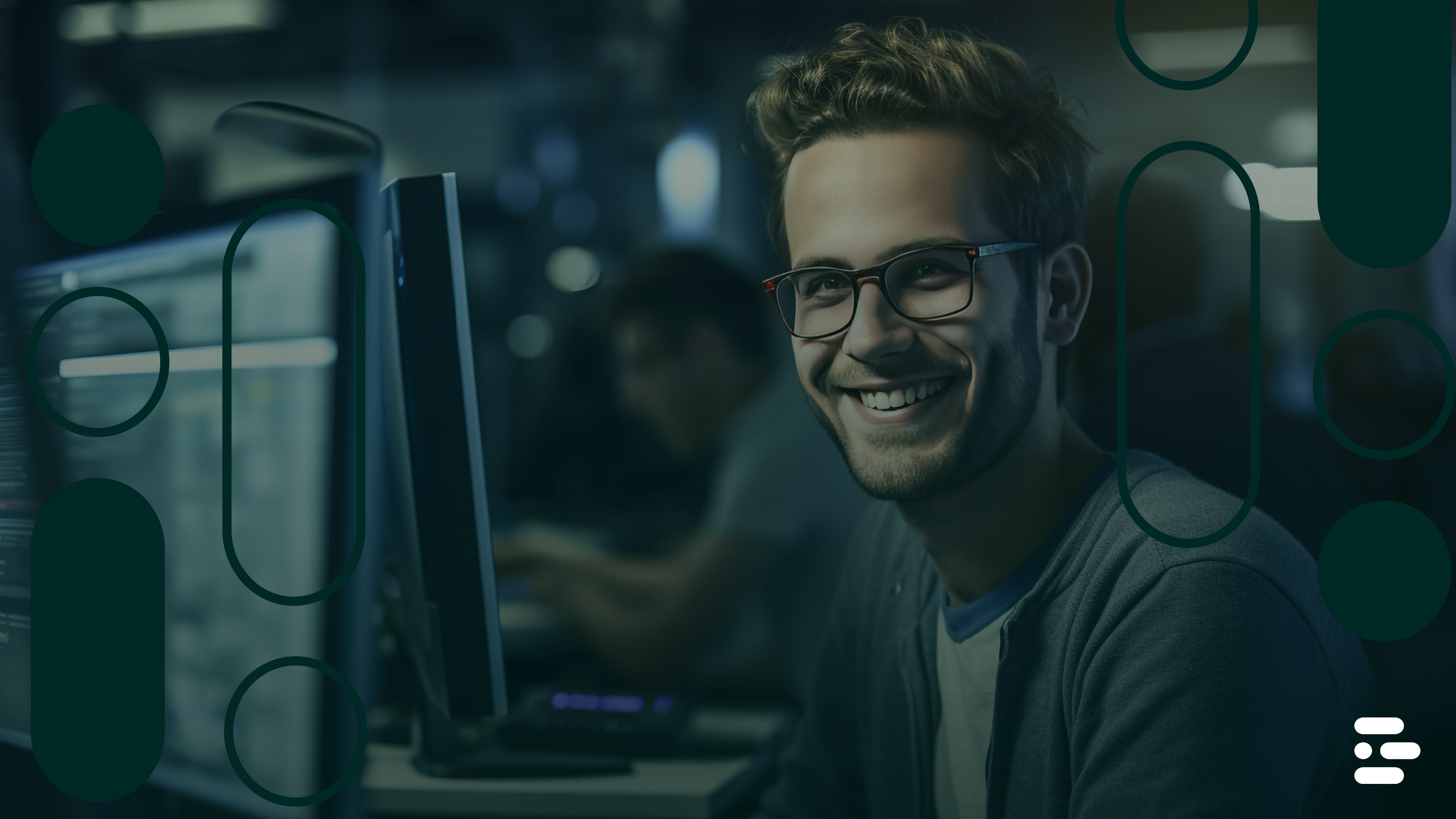 Software developer smiling while working at a computer.
