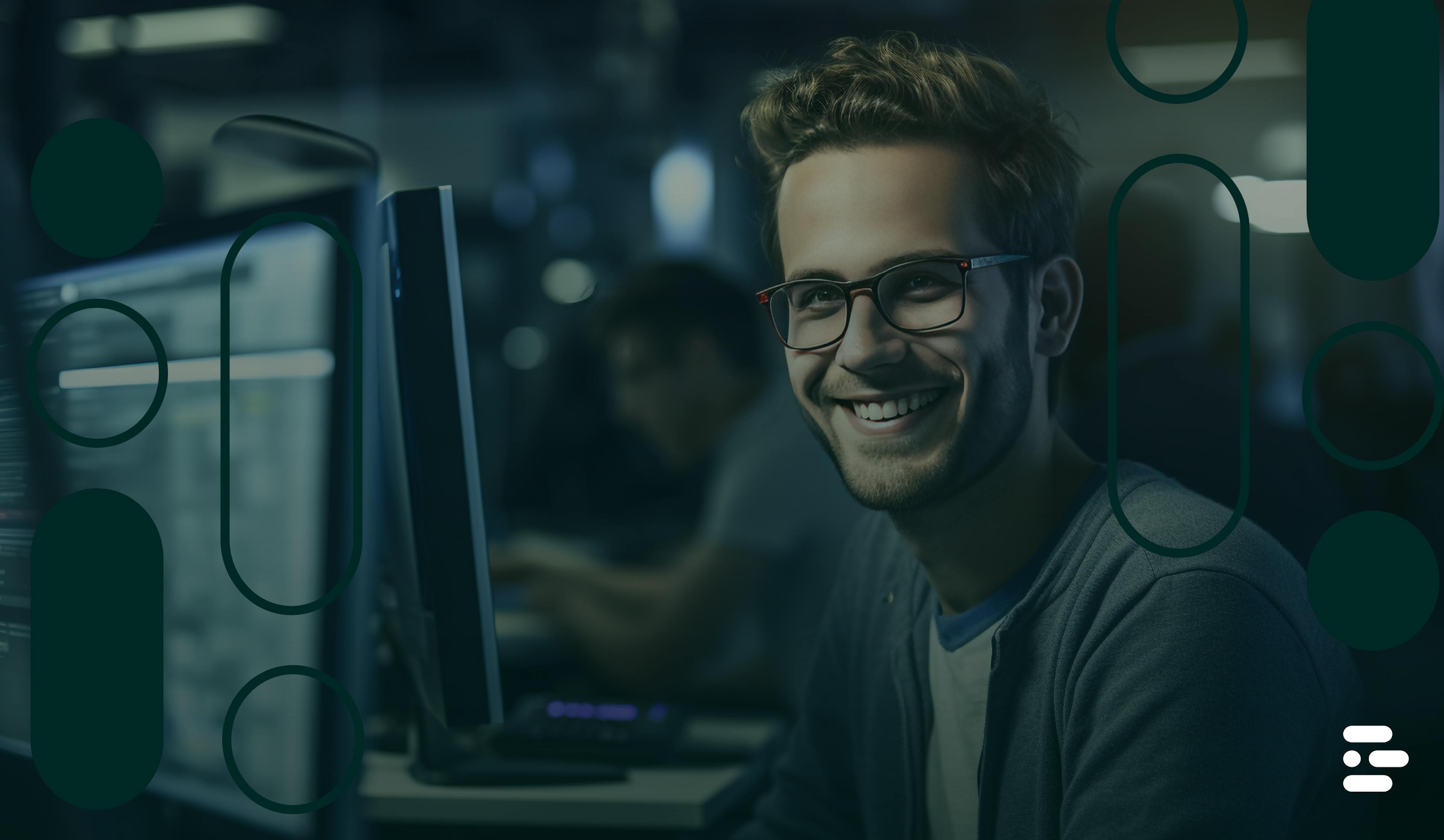 Software developer smiling while working at a computer.