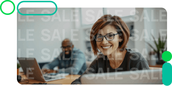 Woman with glasses smiling, using a laptop.