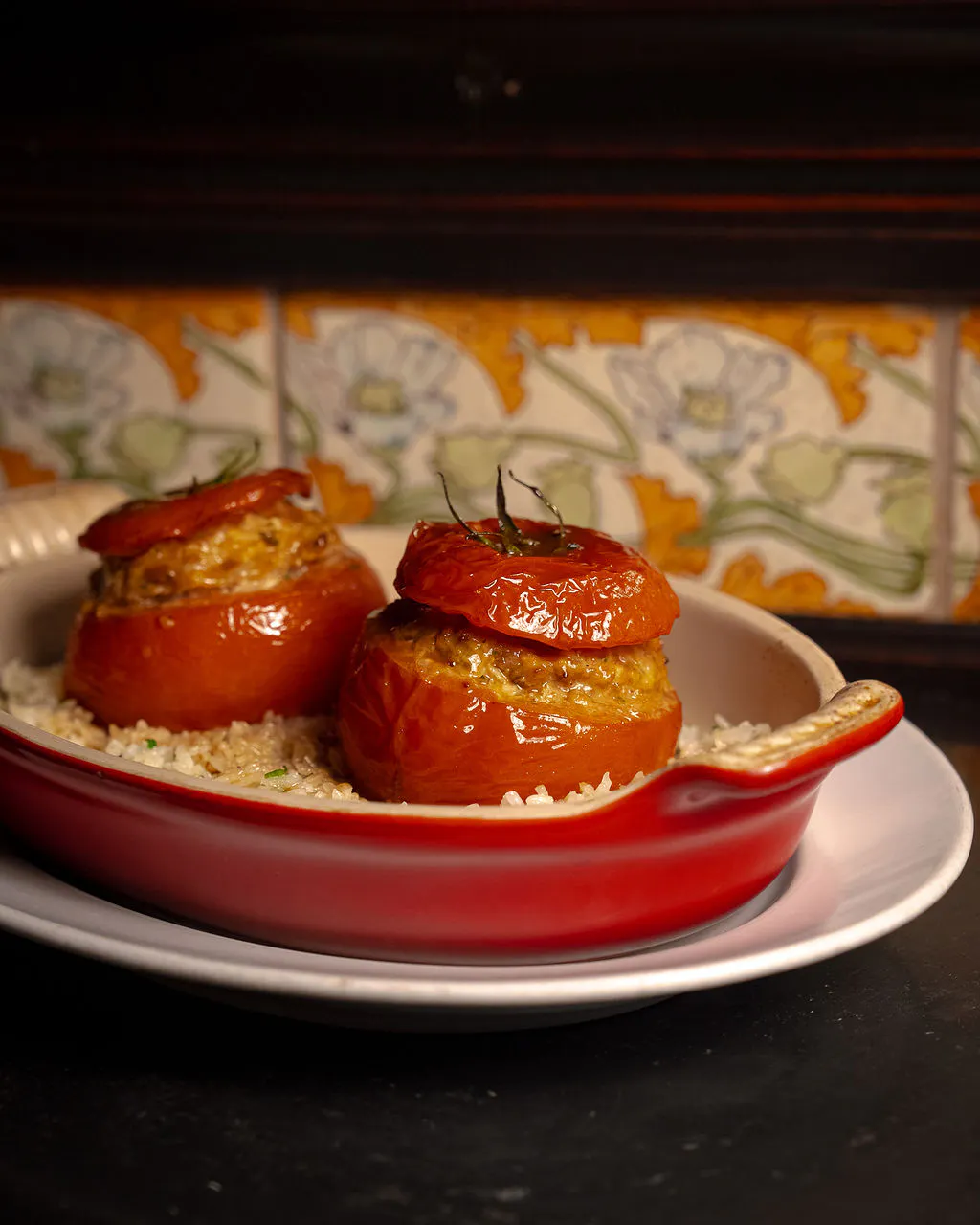 Tomate farcie at Le Gratin, featuring a classic French stuffed tomato with ground pork, veal confit, and rice pilaf.