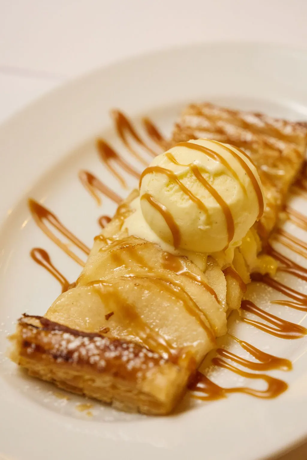 Tarte en bande at Le Gratin, featuring seasonal fruit layered over crisp puff pastry and served with ice cream.