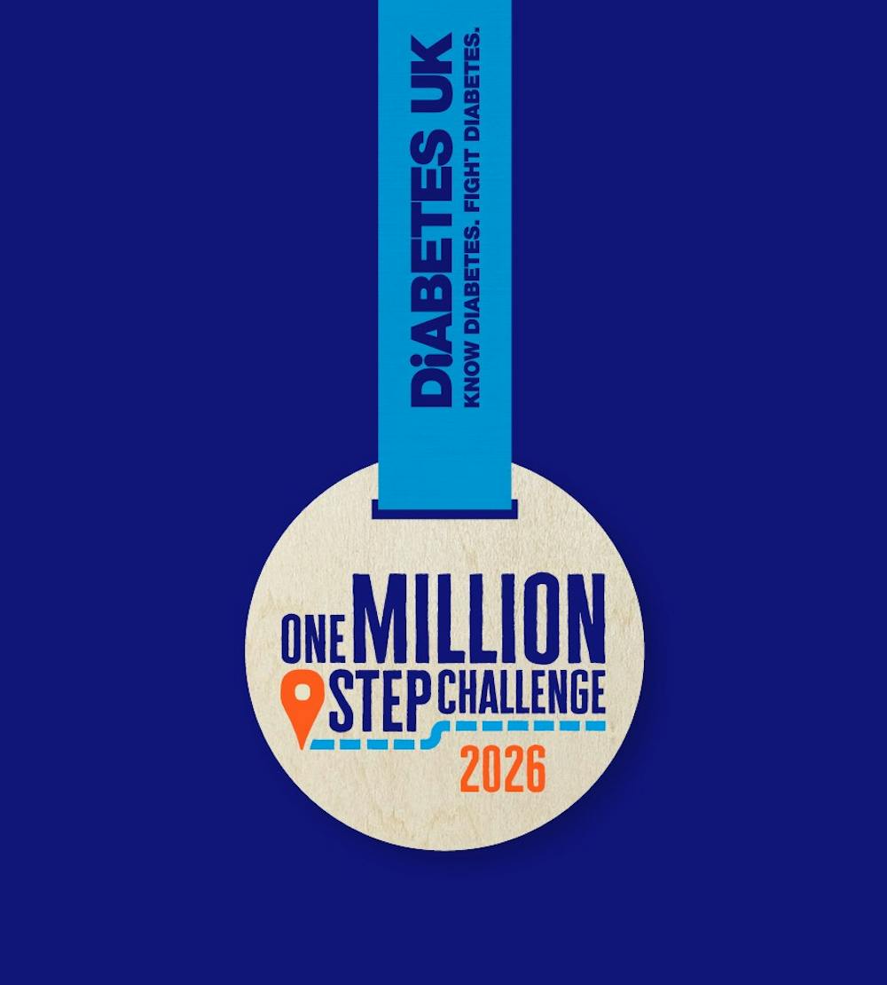 one million step challenge wooden medal with "2026" written on it, in front of a navy background