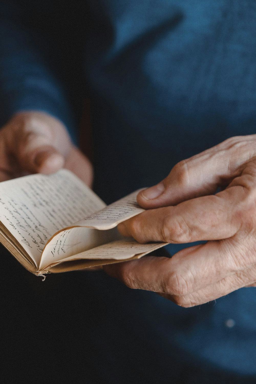 Closeup of hands holding an artifact from the Library's archives