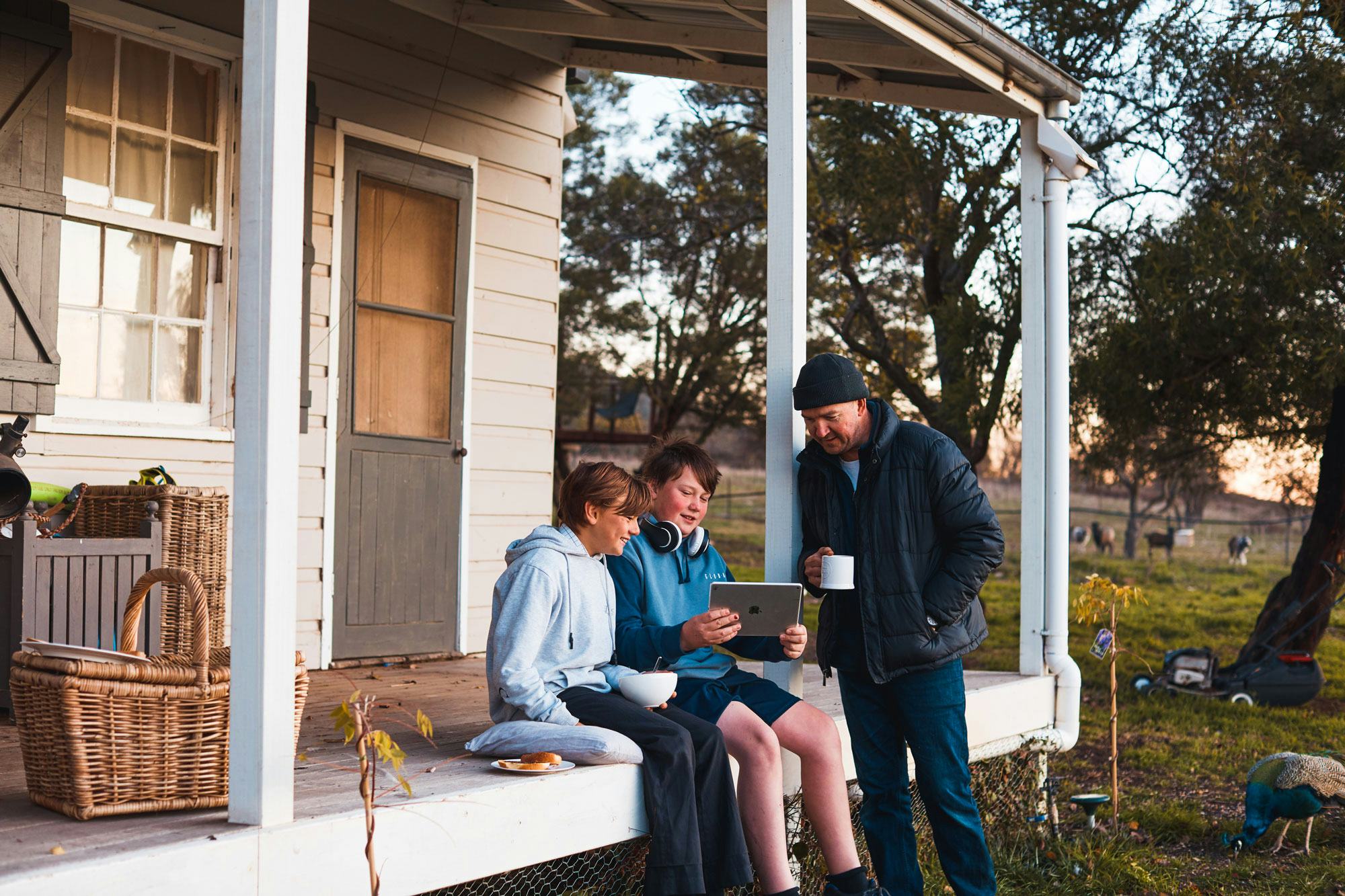 Two boys sitting on a porch in rural Australia