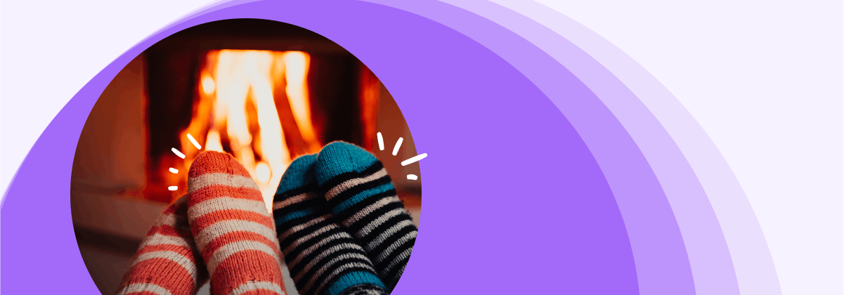 Two people wearing socks and sitting by the fire