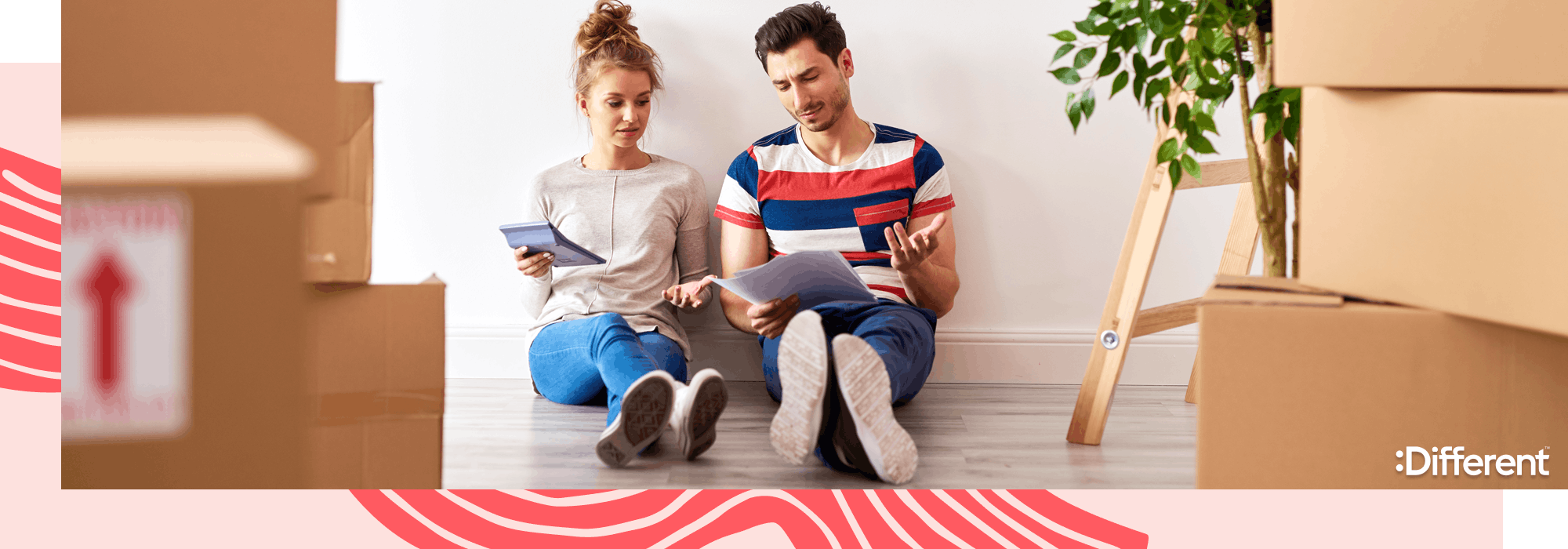 a couple sitting on the floor of their rental apartment worried about rising rental prices