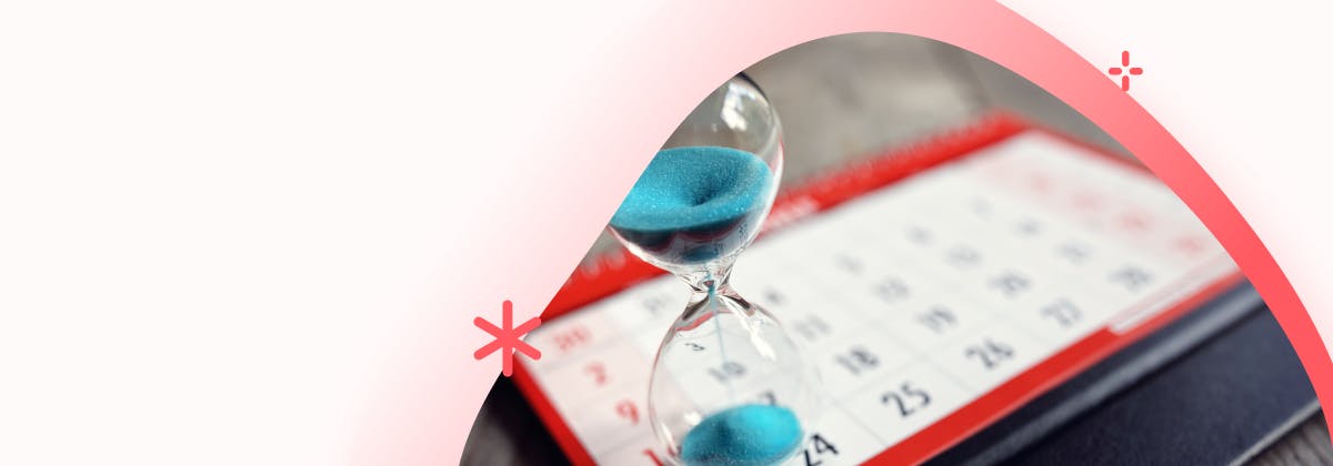 A blue sand hourglass on a calendar board