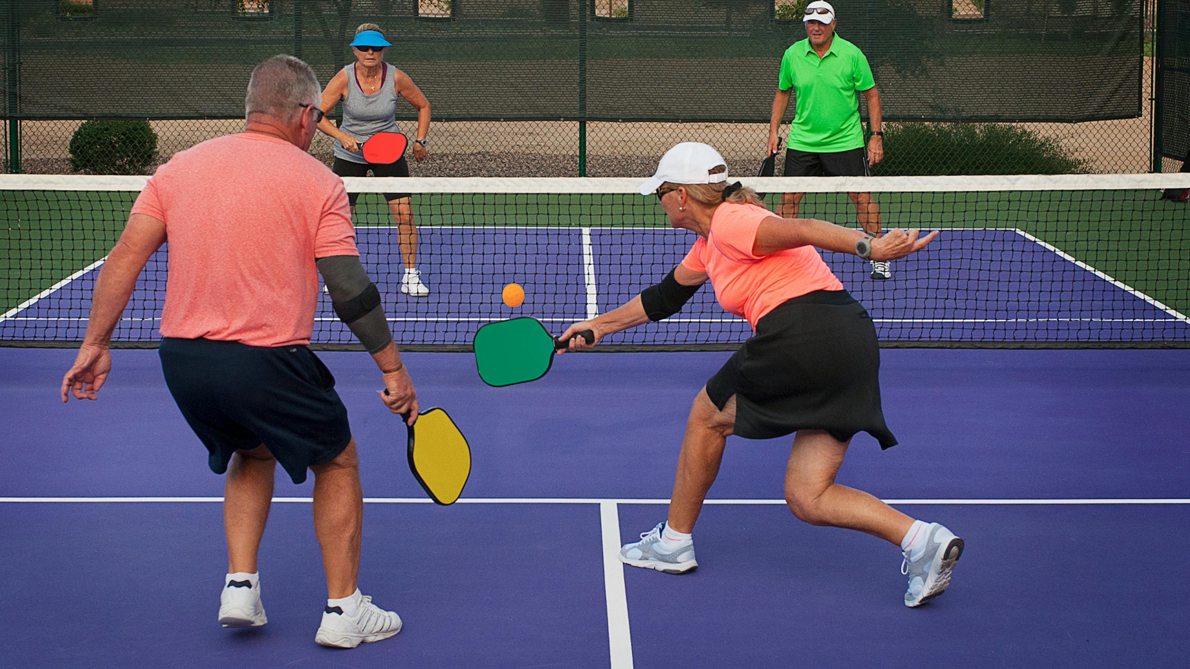 Older people playing pickleball