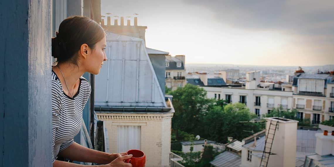 jeune femme fenêtre toit paris
