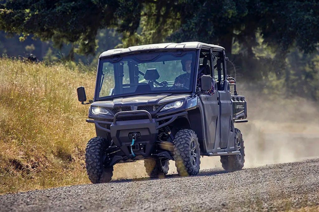 2025 CFMoto UForce 1000 XL driving down a gravel road.