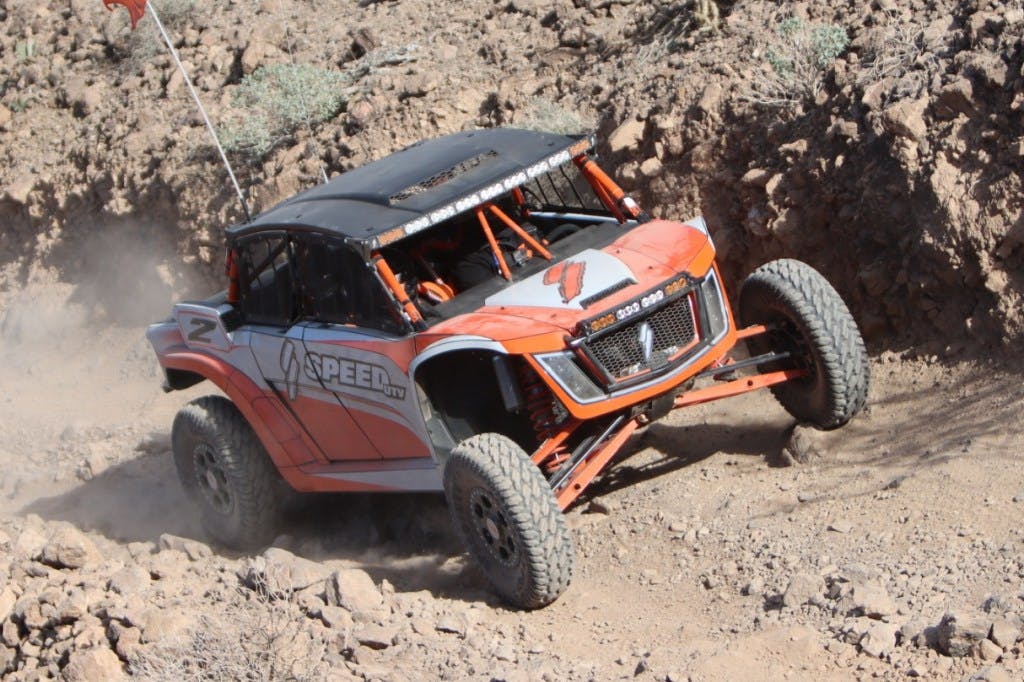 2025 speed utv el jefe climbing up a rocky trail.