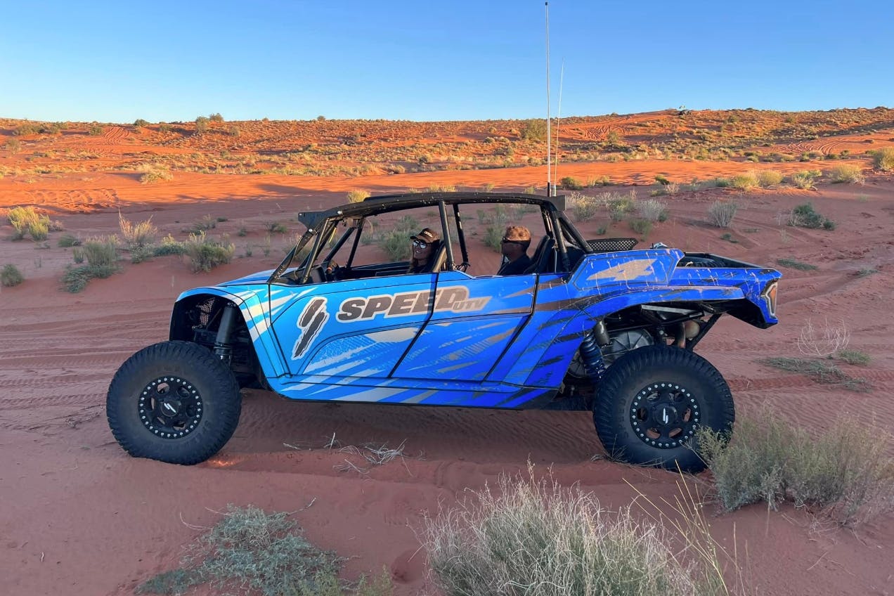 2025 speed utv el jefe with blue wrap parked in the desert.