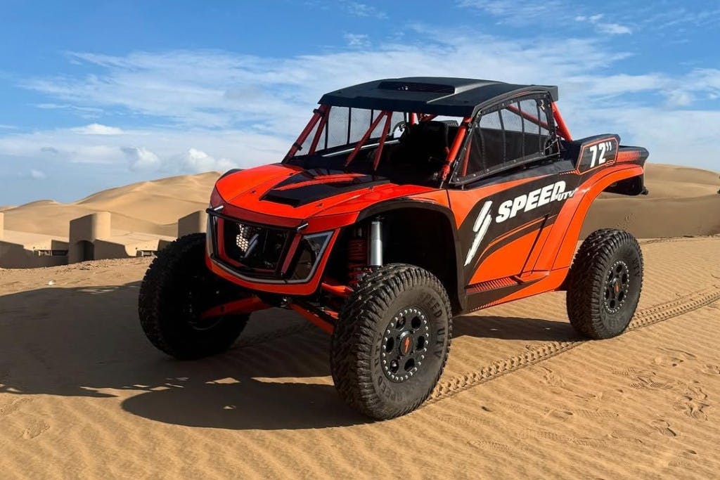 2025 speed utv baja bandit parked on a sand dune.