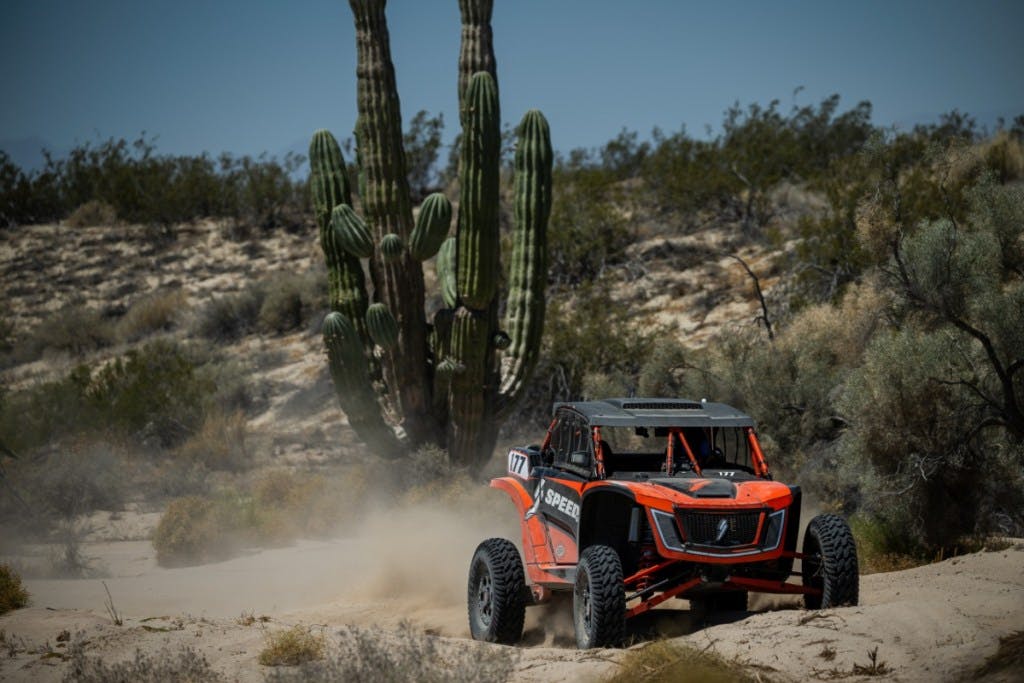 2025 speed utv baja bandit driving on a desert course.