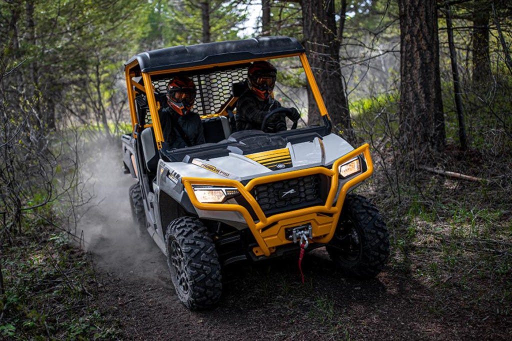 2025 arctic cat prowler riding through a wooded trail.