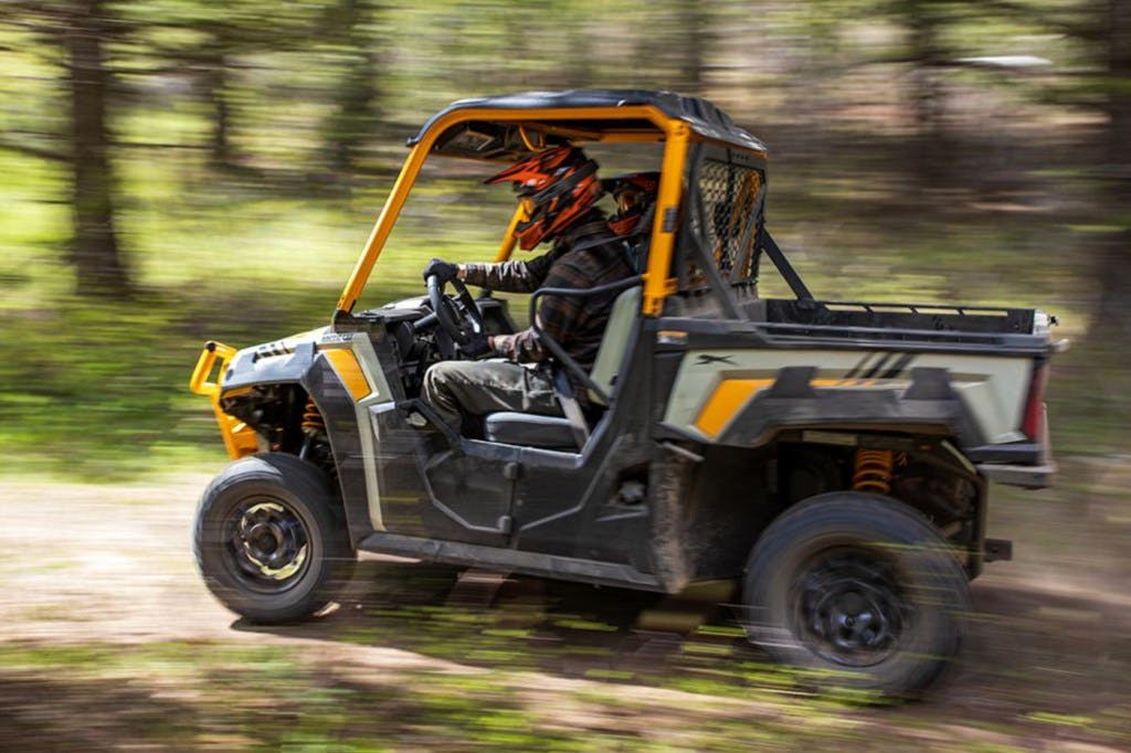2025 arctic cat prowler riding down a gravel road.
