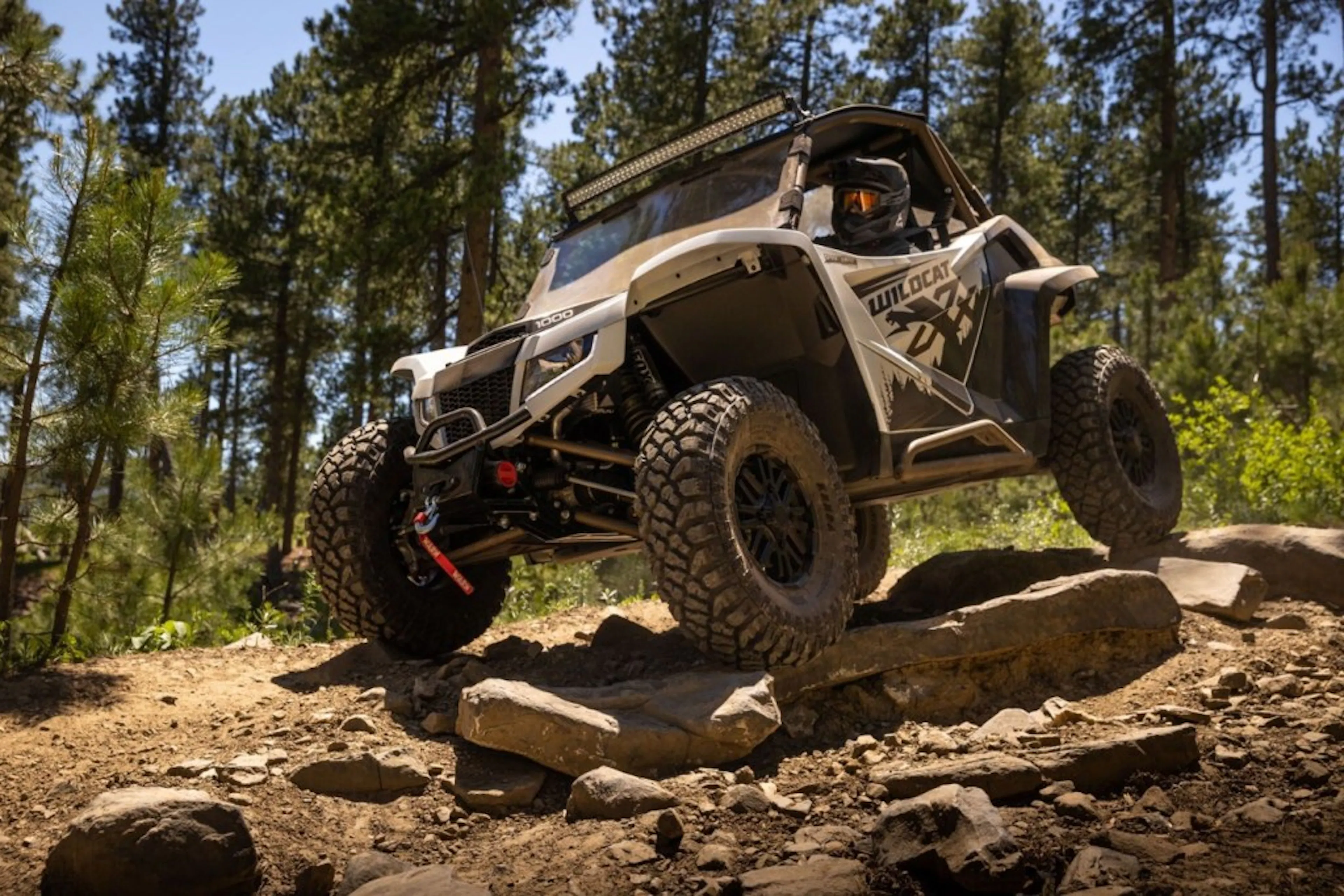 2025 arctic cat wildcat xx making its way down a rocky trail.