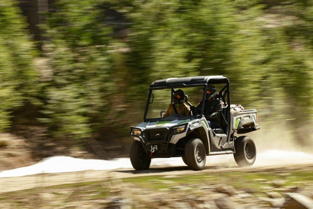 2025 arctic cat prowler riding down a dirt road.
