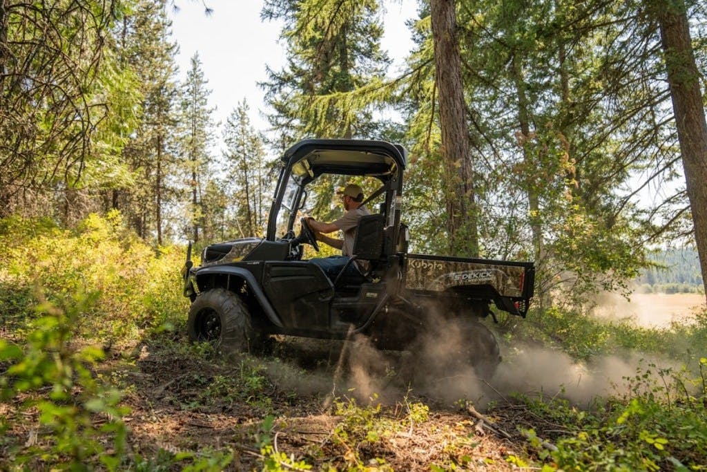 2025 Kubota Sidekick cutting through the woods.