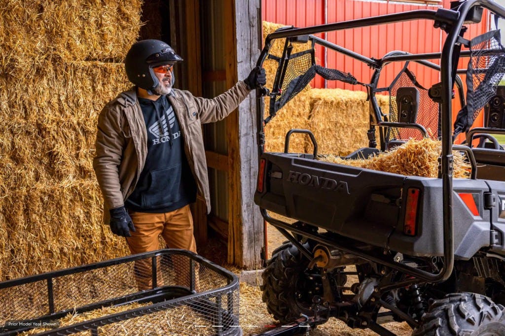 2025 Honda Pioneer 700-4 being loaded with hay bales.