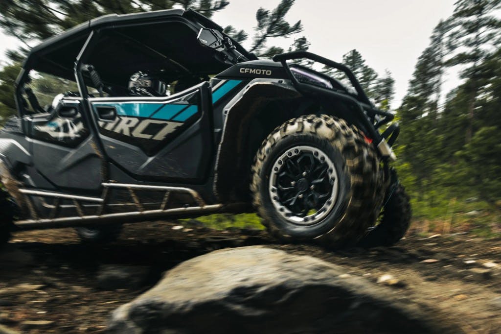 2025 CFMoto ZForce 950 Sport-4 driving over a rock.