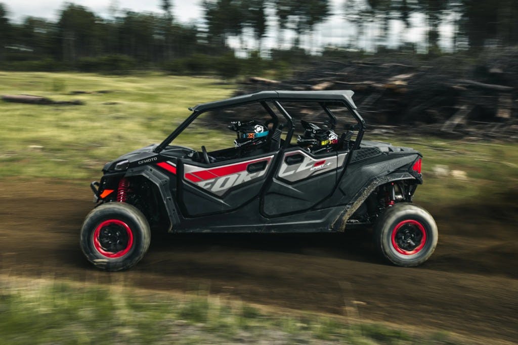 2025 CFMoto ZForce 950 Sport-4 drifing with helpless children strapped into the back seat.
