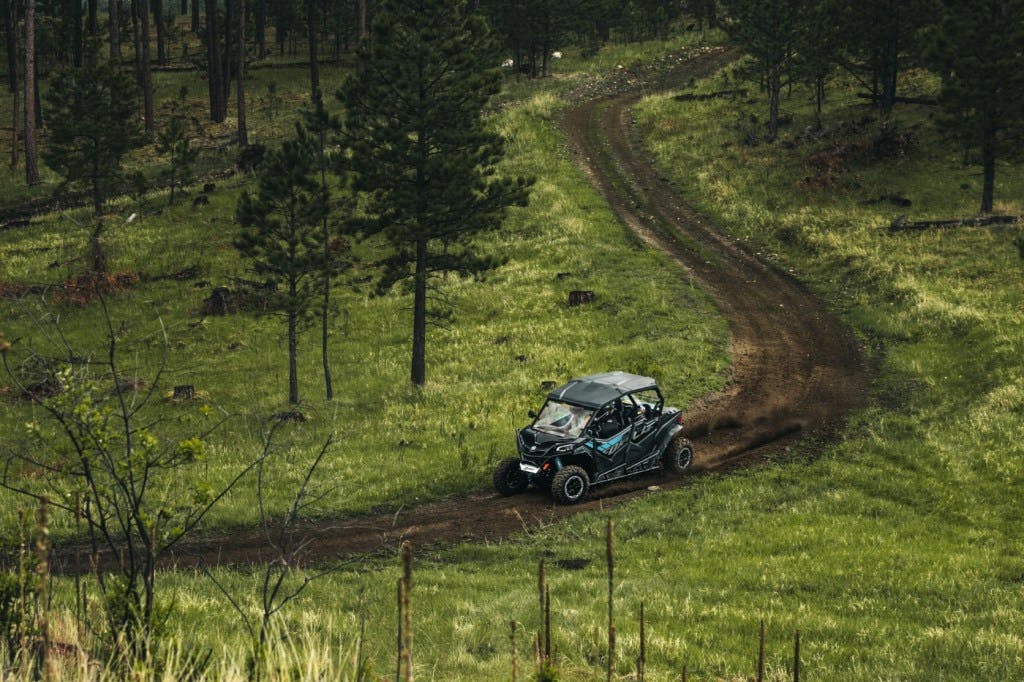 2025 CFMoto ZForce 950 Sport-4 breaking right on dirt two track.