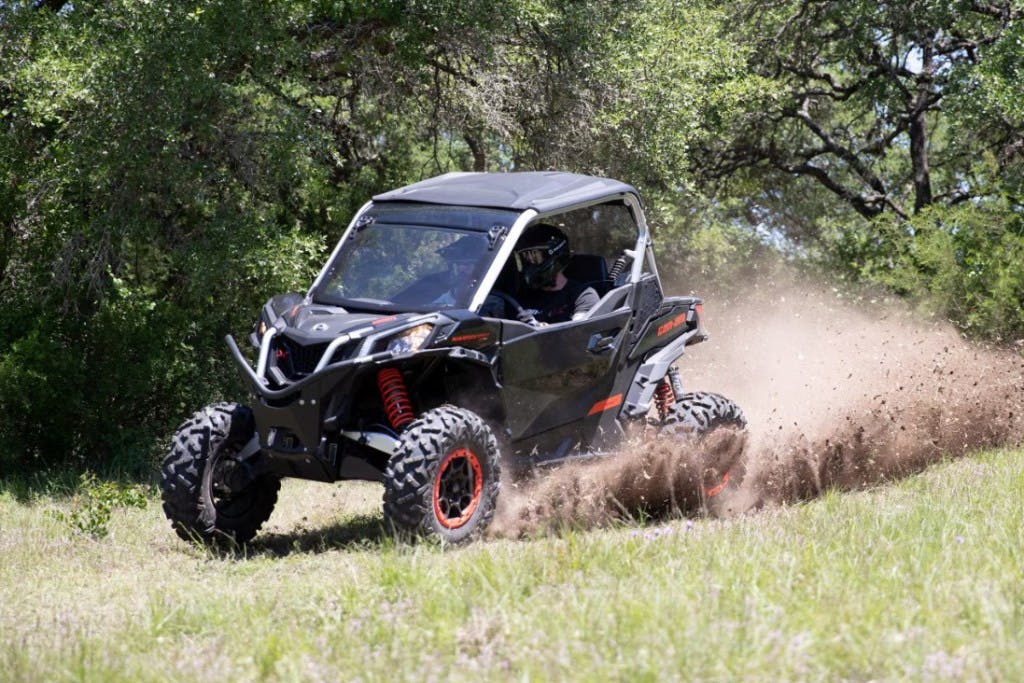2025 Can-Am Maverick Sport cornering in the dirt.
