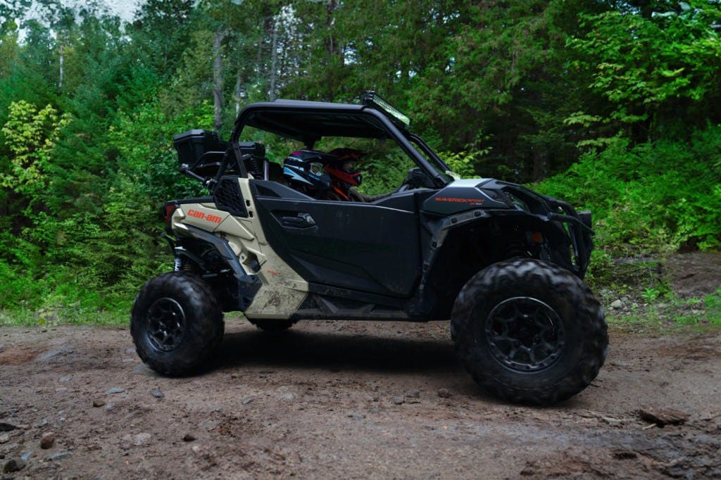 2025 Can-Am Maverick Sport cruising down a trail.