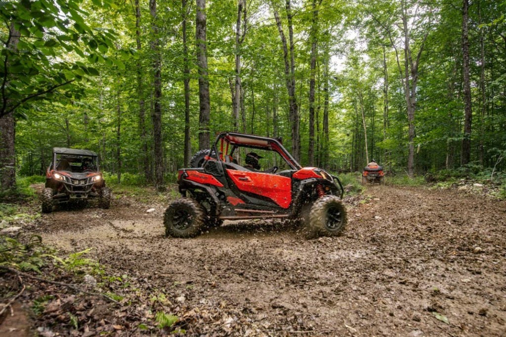 2025 Can-Am Maverick Sport cornering in the mud.