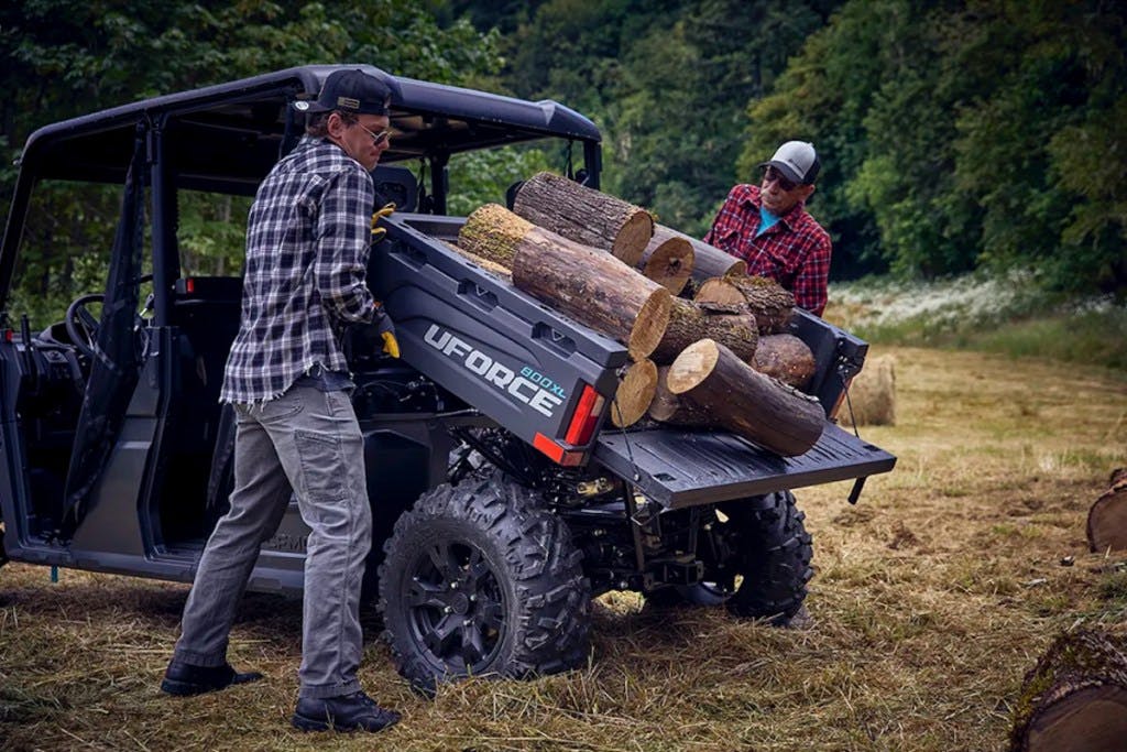 2025 CFMoto UForce 800 XL dumping a bed of wood.