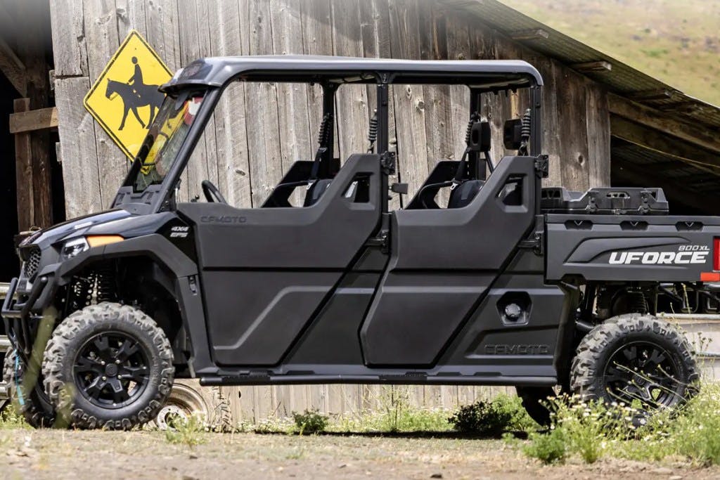 2025 CFMoto UForce 800 XL with full doors parked outside a barn.