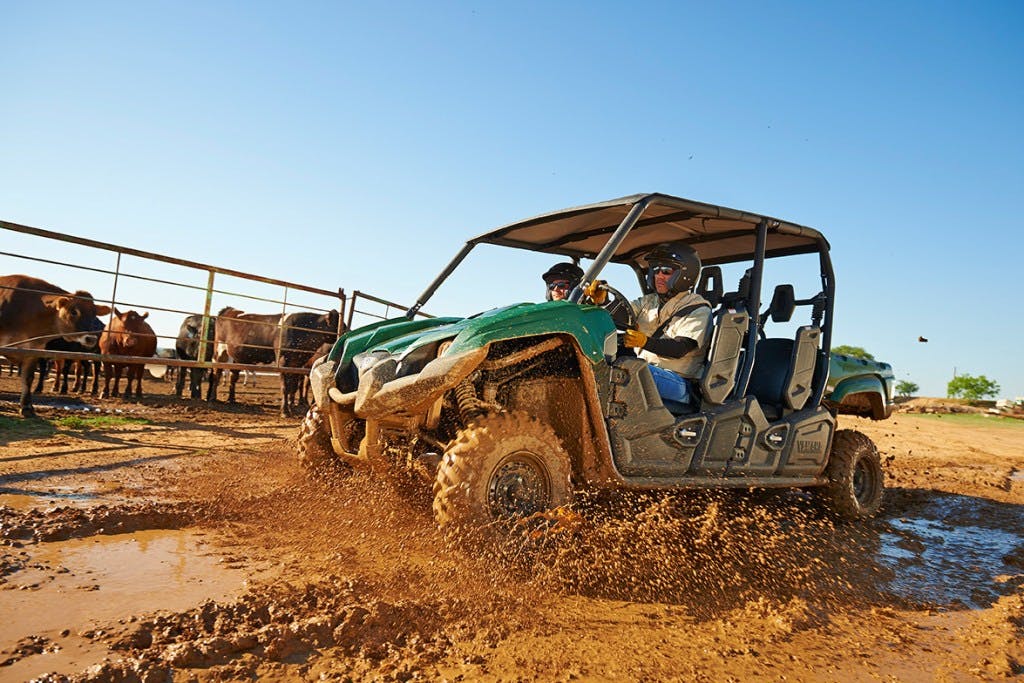 2025 yamaha viking VI driving through mud while some cows watch.