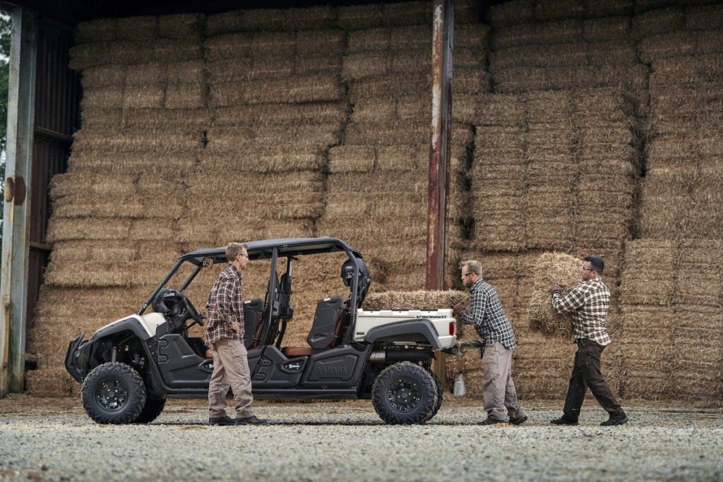 2025 yamaha viking VI ranch edition being loaded by three dudes in plaid shirts, cargo pants, matching haircuts, and safety glasses.