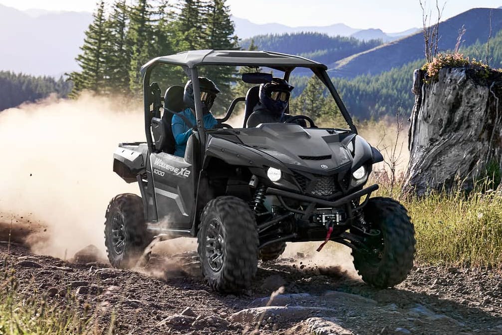 2025 yamaha wolverine x2 1000 kicking up dust on a rocky trail.