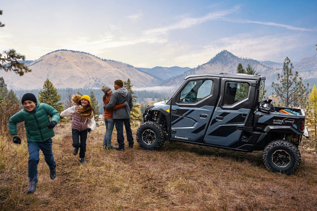 2025 Kawasaki Ridge XR crew parked beside the ideal nuclear family.