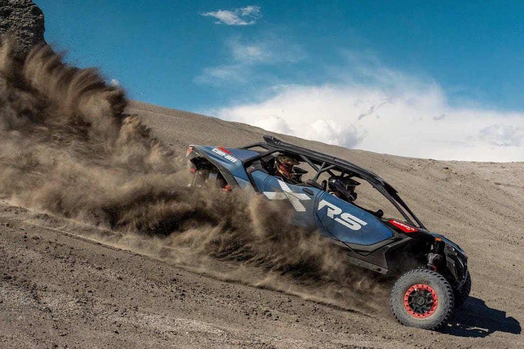 Can-Am Maverick R Max sliding through sand in the desert.