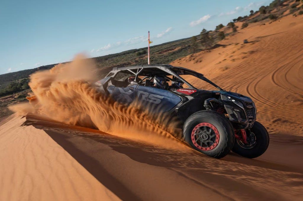 Can-Am Maverick R Max X RS with Smart-Shox driving in sand dunes.