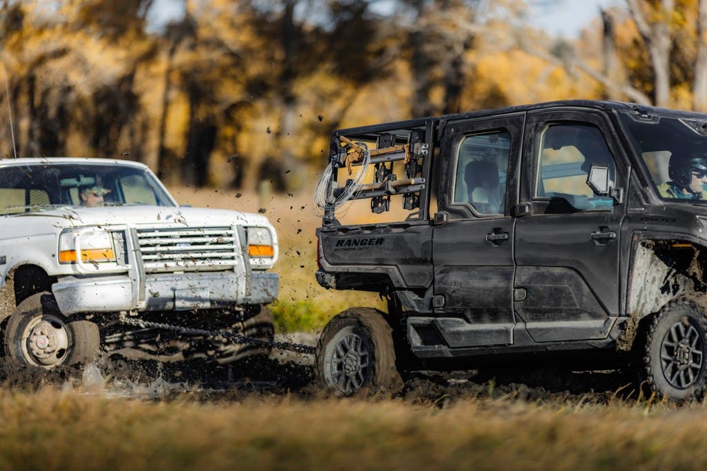 2025 Polaris Ranger Crew XD 1500 pulling a Ford truck out of the mud
