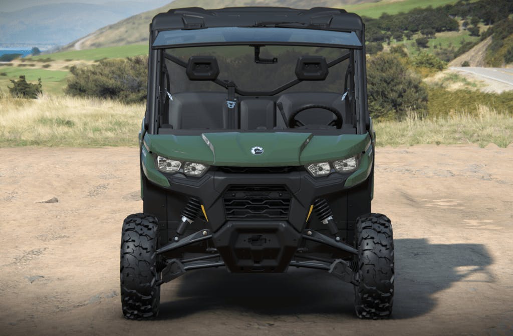 2025 Can-Am Defender DPS green front angle on sand