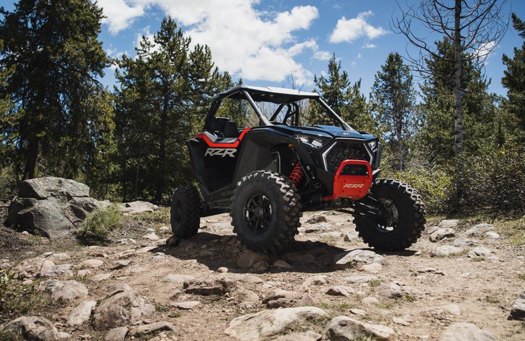 2025 Polaris RZR Pro XP woods rocks fir trees blue sky California