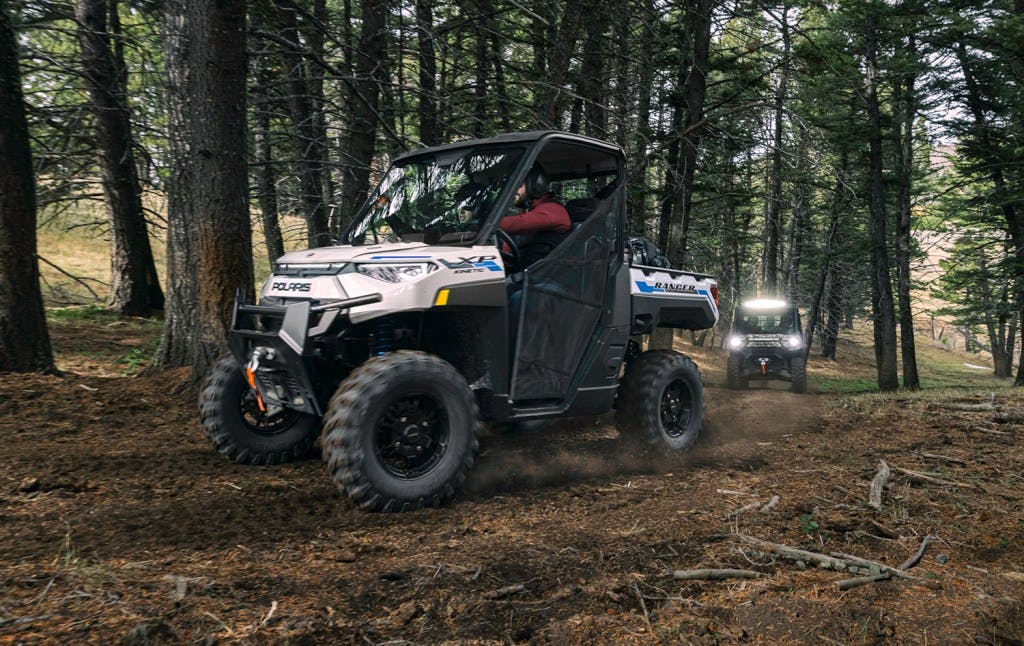 2024 Polaris Ranger Kinetic EV in a forest with tall trees