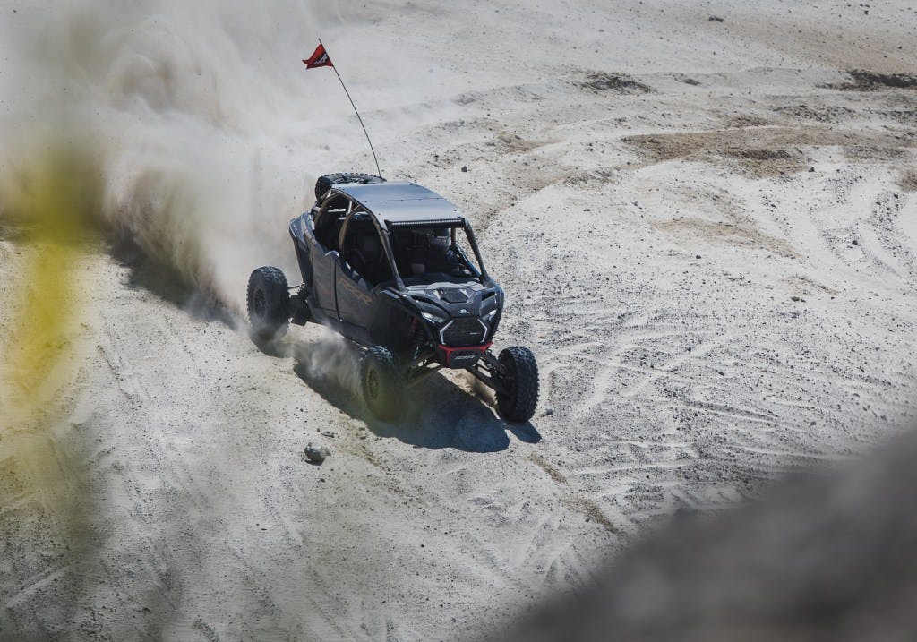 2025 Polaris RZR Pro R sliding in sand dunes