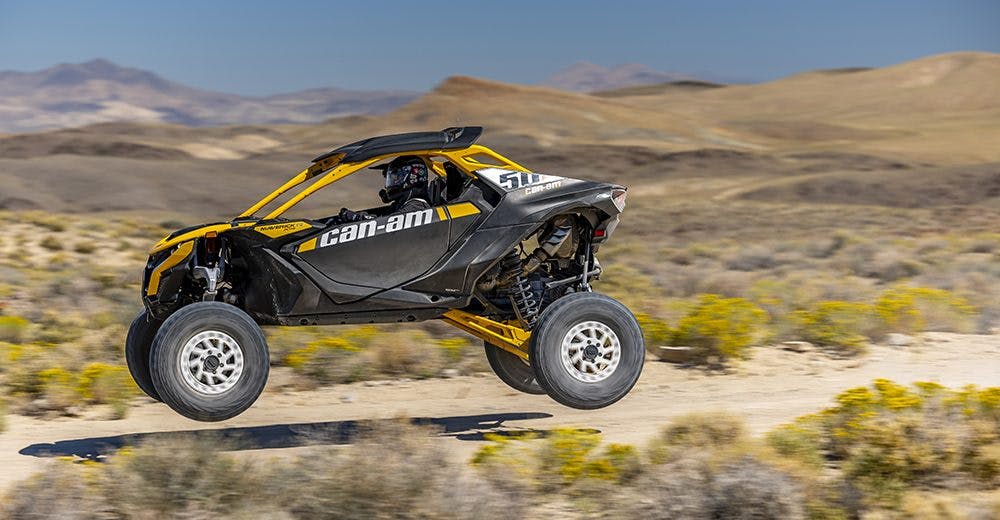 2025 Can-Am Maverick R jumping in the desert.