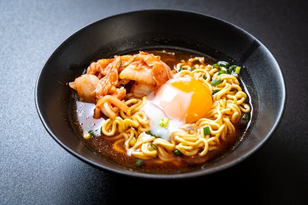 spicy noodles with kimchi and a poached egg 