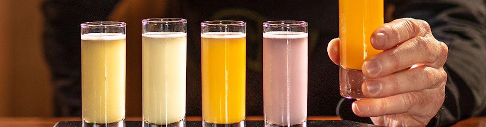 Kombucha drinks being prepared by barman