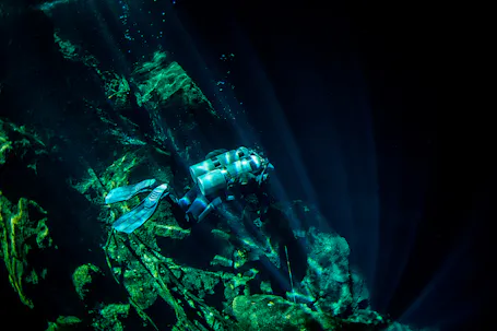 scuba diver diving in overhead underwater